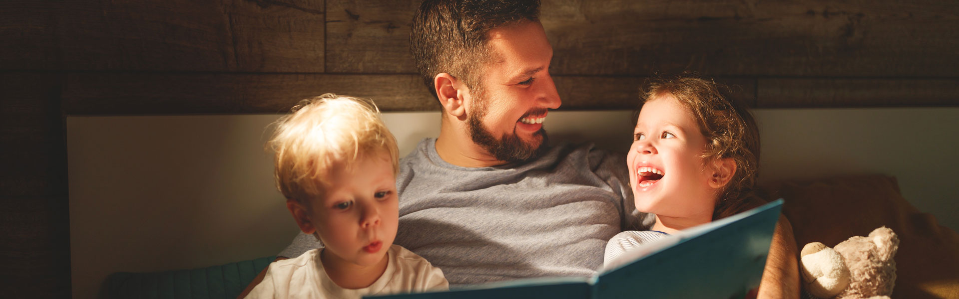 Family reading in a lighted housed